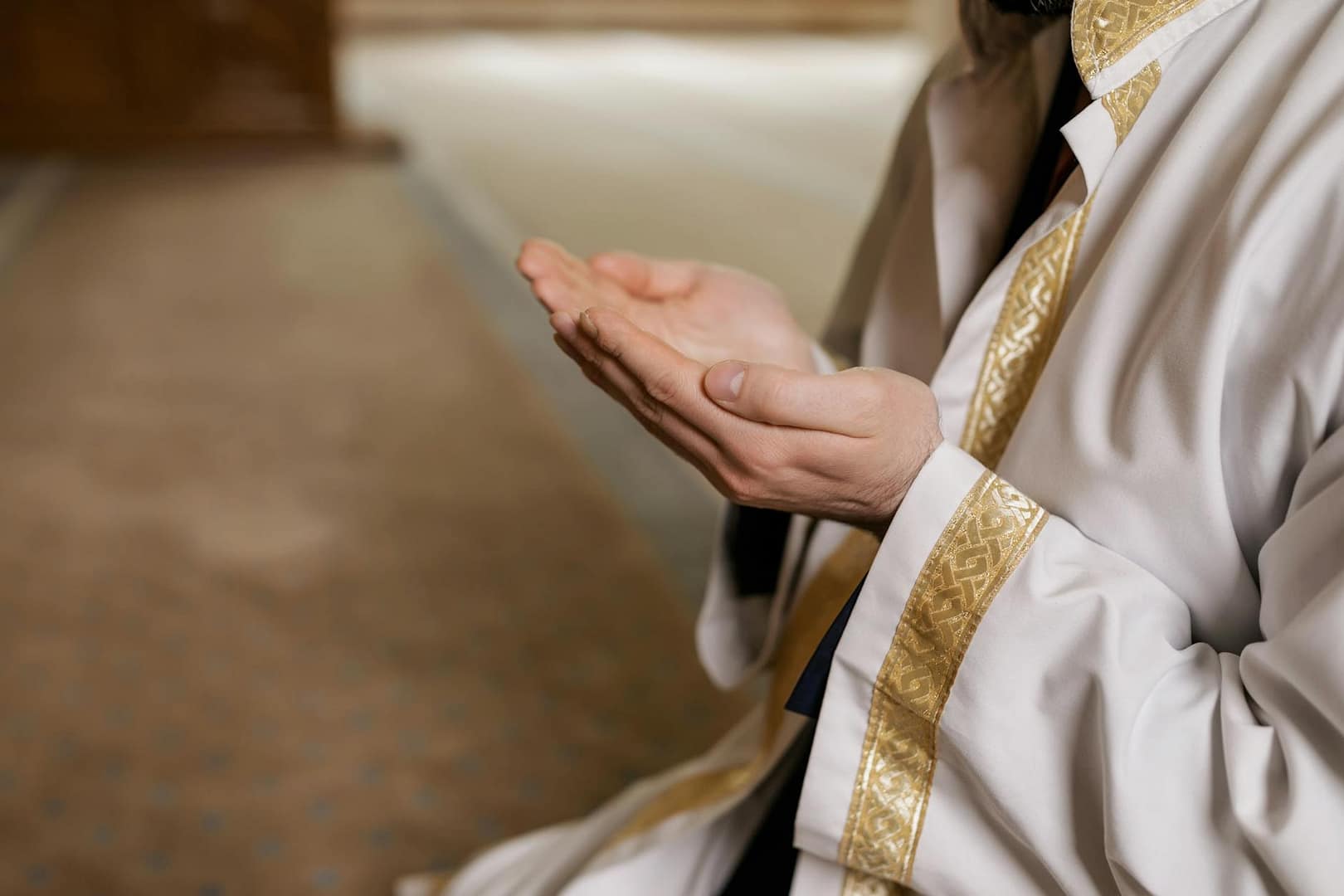 person in praying with his hands raised
