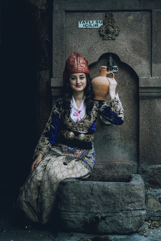 Woman in Traditional Dress Posing with Vase