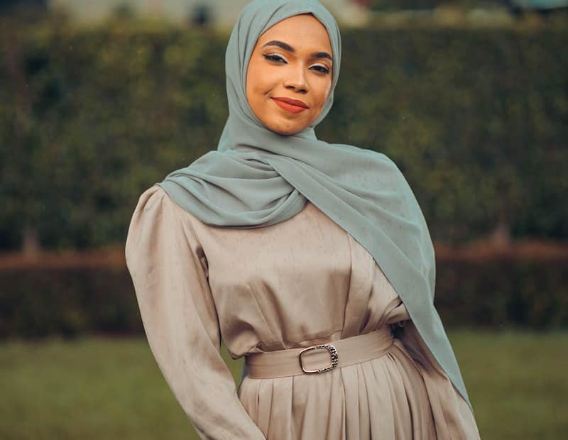 Portrait of a confident woman in a hijab, exuding elegance and grace in a natural setting.