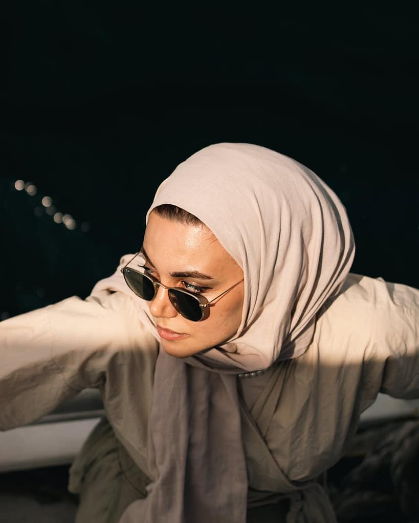 Photo of a Young Woman Wearing a Hijab and Sunglasses