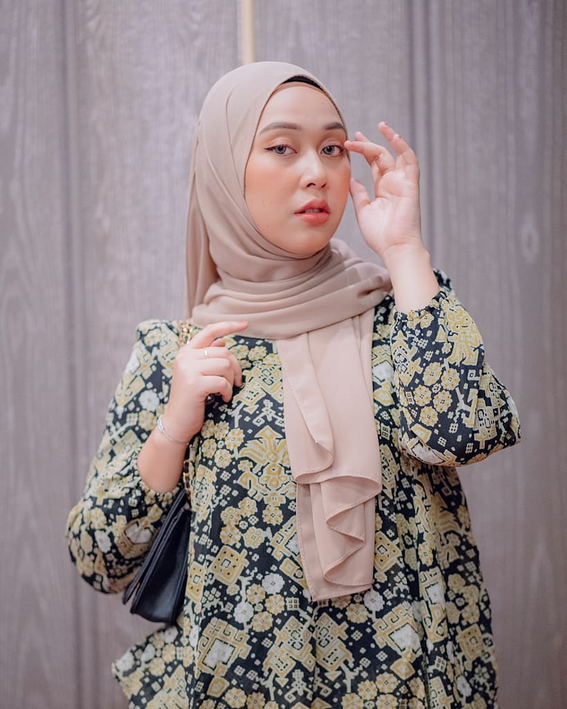 a woman in a hijab holding an umbrella