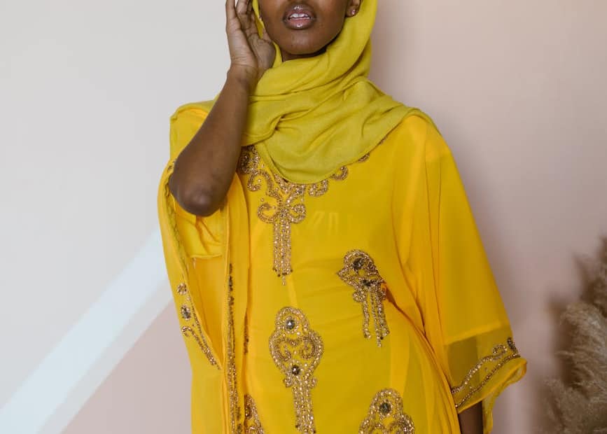 a woman wearing yellow dress paired with a yellow hijab