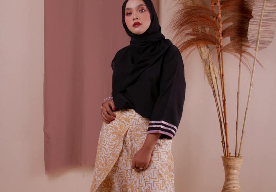 woman in black hijab and brown dress