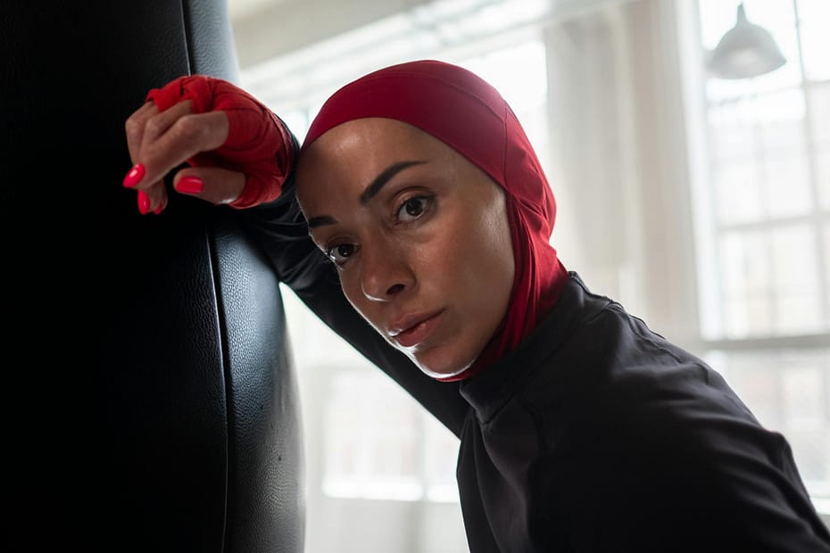 a woman wearing red hijab and hand wraps