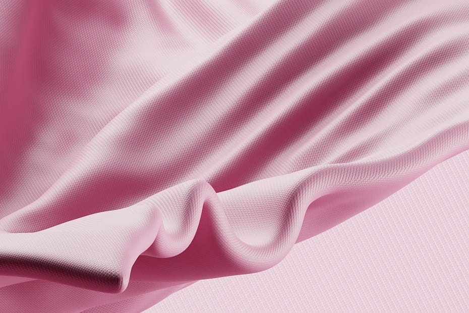 a close up of a pink fabric on a pink background